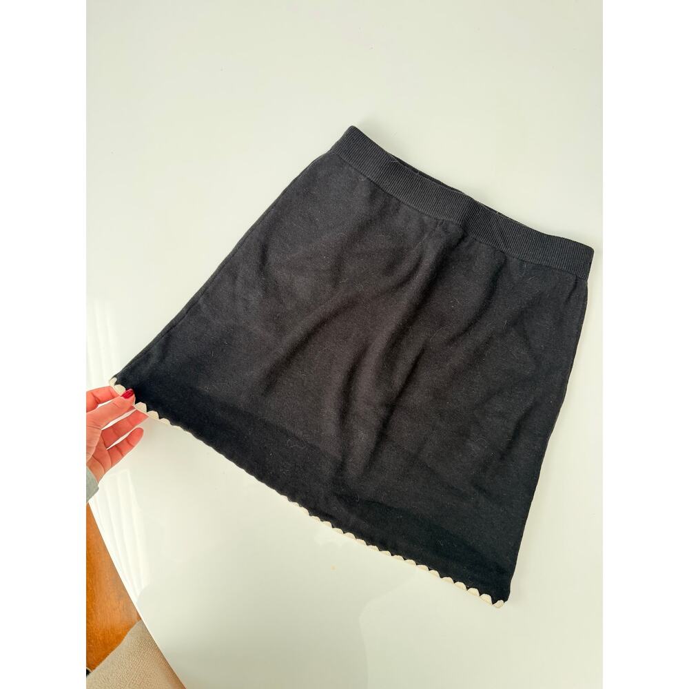 Knot black mini skirt with white scalloped trim